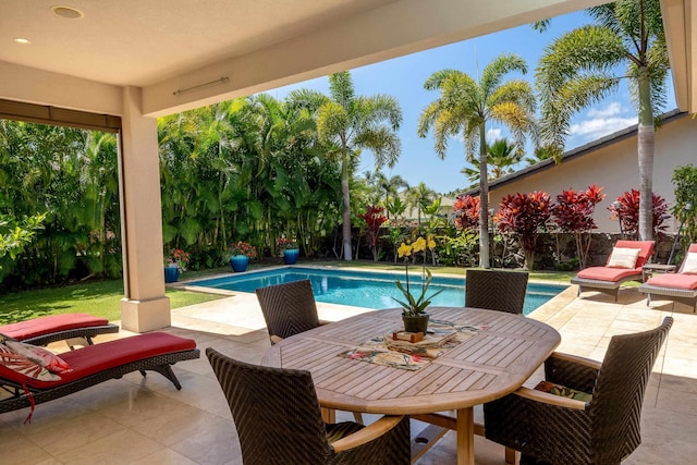pool featuring a fenced backyard, outdoor dining space, and a patio area