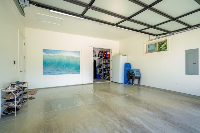 garage with electric panel and freestanding refrigerator