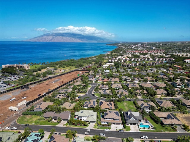 birds eye view of property with a water and mountain view
