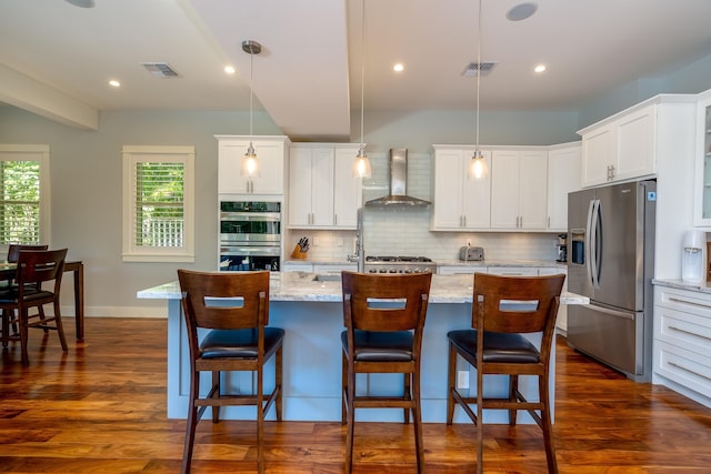 kitchen with visible vents, stainless steel appliances, wall chimney range hood, and dark wood-style flooring