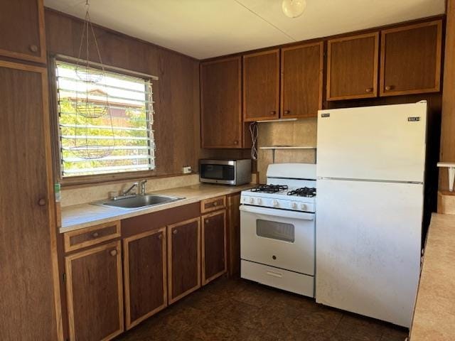 kitchen featuring sink and white appliances