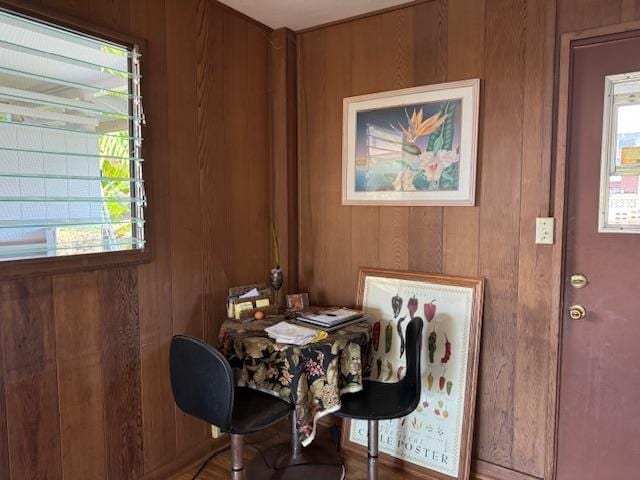 dining room with wood walls