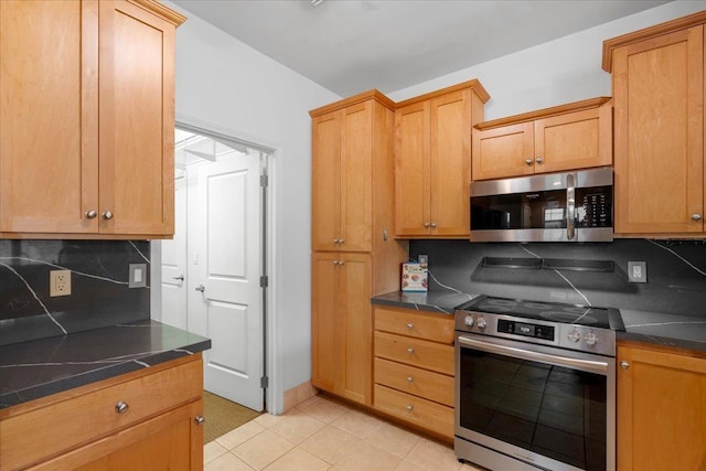 237 Kuli Puu St, Kihei, HI 96753 - kitchen featuring appliances with stainless steel finishes, dark countertops, decorative backsplash, and light tile patterned floors