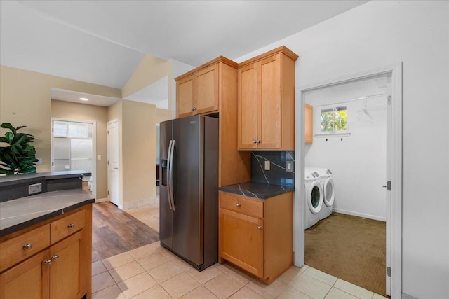 237 Kuli Puu St, Kihei, HI 96753 - kitchen featuring stainless steel fridge, independent washer and dryer, lofted ceiling, dark countertops, and backsplash