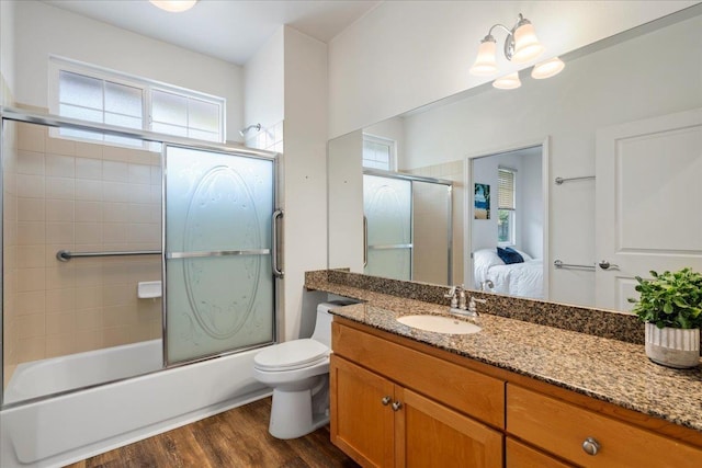 237 Kuli Puu St, Kihei, HI 96753 - ensuite bathroom featuring vanity, wood finished floors, shower / bath combination with glass door, and toilet