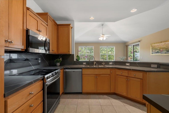 237 Kuli Puu St, Kihei, HI 96753 - kitchen featuring appliances with stainless steel finishes, a sink, dark countertops, light tile patterned flooring, and recessed lighting