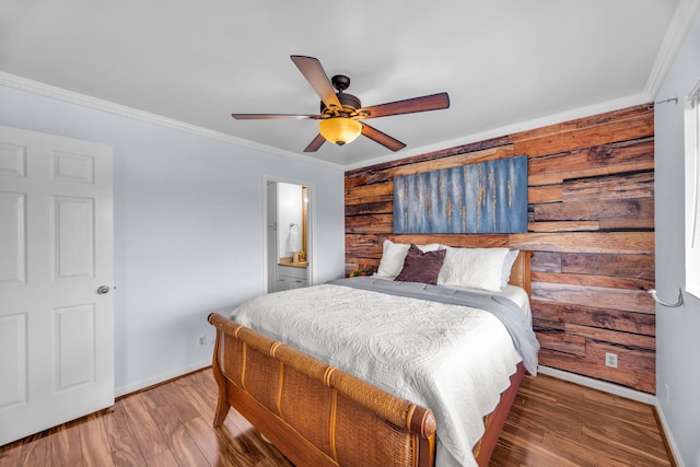 bedroom with baseboards, ornamental molding, and wood finished floors
