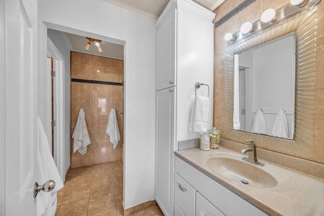 bathroom with vanity, tile patterned floors, and a tile shower