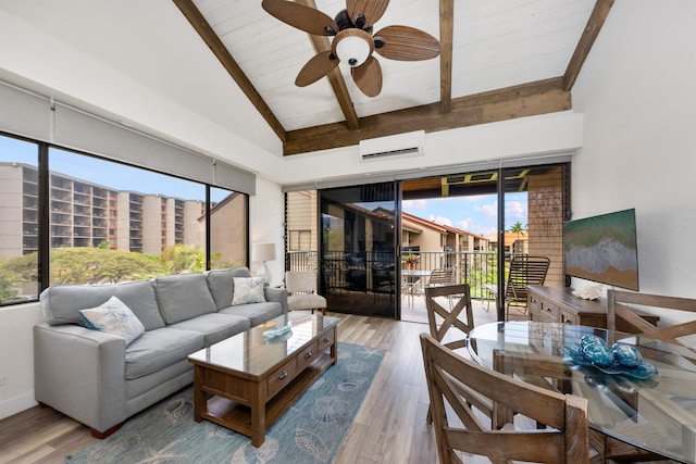 living room with a wall unit AC, beamed ceiling, hardwood / wood-style flooring, high vaulted ceiling, and ceiling fan