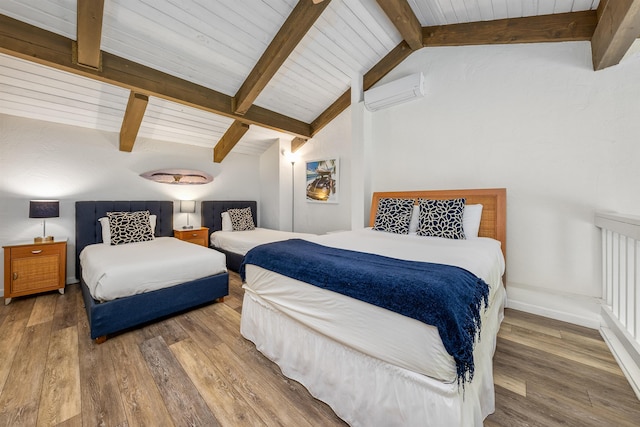 bedroom with hardwood / wood-style flooring, vaulted ceiling with beams, and a wall mounted air conditioner