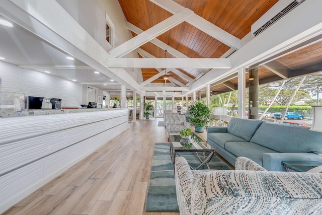 interior space featuring an AC wall unit, light hardwood / wood-style floors, vaulted ceiling with beams, and wood ceiling