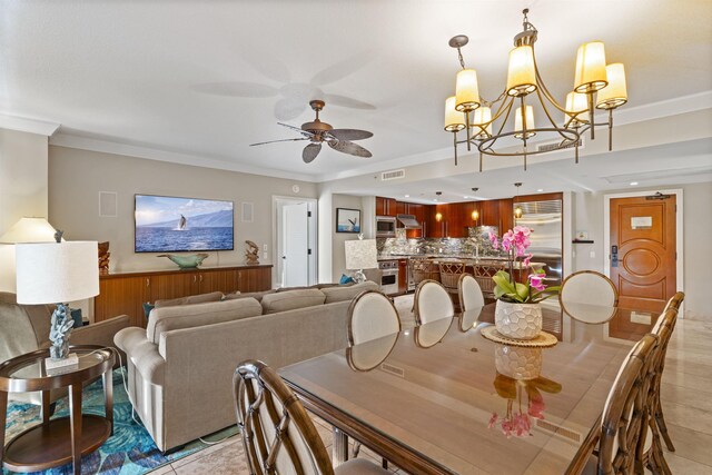 dining room featuring ornamental molding, ceiling fan with notable chandelier, and light tile patterned flooring