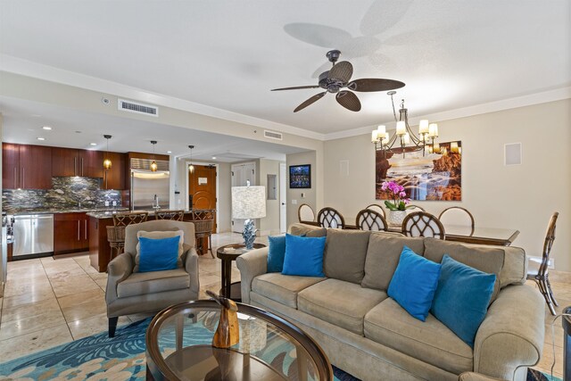 tiled living room featuring ornamental molding and ceiling fan with notable chandelier