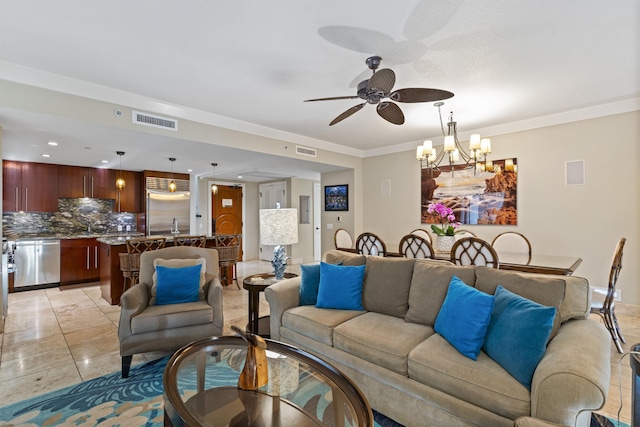 living room featuring crown molding, visible vents, and ceiling fan with notable chandelier