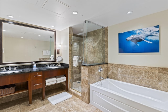 full bathroom with double vanity, recessed lighting, a sink, a stall shower, and a garden tub