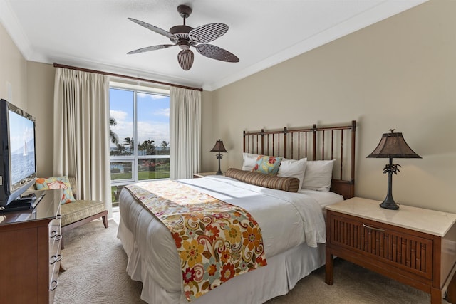 bedroom with crown molding, carpet flooring, and a ceiling fan