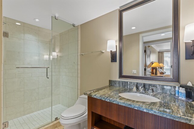 bathroom with walk in shower, toilet, and vanity