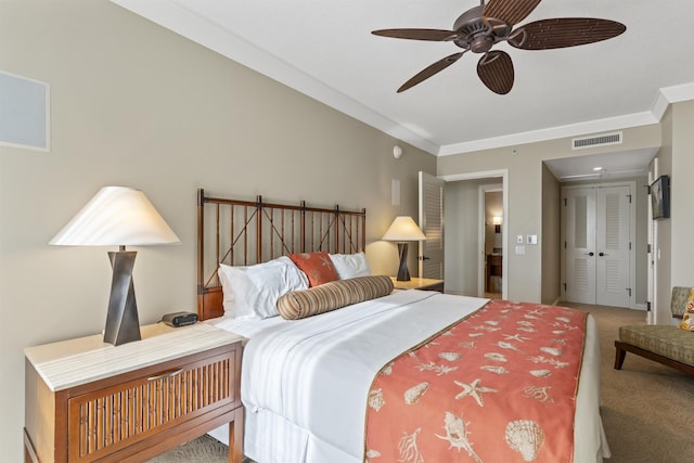 bedroom featuring visible vents, ornamental molding, carpet, and a ceiling fan
