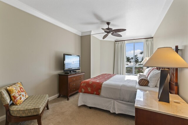 bedroom featuring ornamental molding, light colored carpet, and ceiling fan