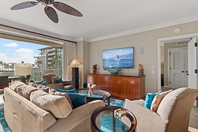 living room with ceiling fan and crown molding