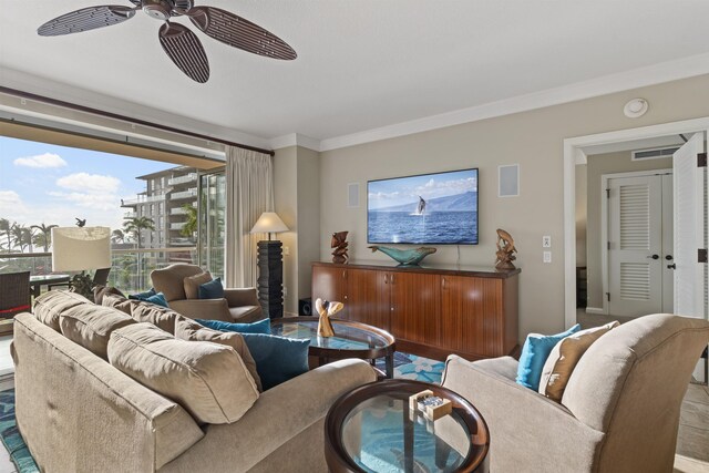 living room with visible vents, ornamental molding, and ceiling fan