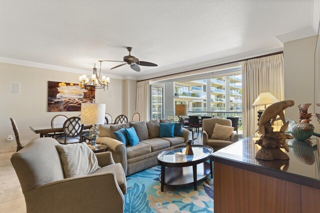 living room featuring a textured ceiling, ornamental molding, and ceiling fan with notable chandelier