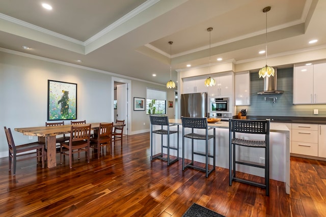 806 Kukia Pl, Kula, HI 96790 - kitchen with a tray ceiling, dark countertops, wall chimney range hood, dark wood-type flooring, and ornamental molding