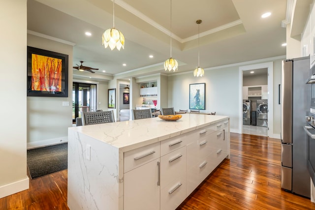 806 Kukia Pl, Kula, HI 96790 - kitchen with washer and clothes dryer, dark wood-type flooring, white cabinetry, a center island, and modern cabinets
