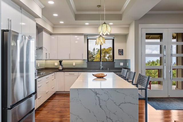 806 Kukia Pl, Kula, HI 96790 - kitchen with freestanding refrigerator, modern cabinets, dark wood-type flooring, healthy amount of natural light, and crown molding