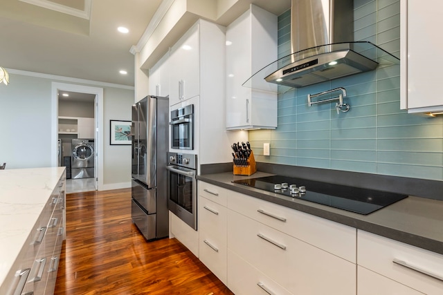 806 Kukia Pl, Kula, HI 96790 - kitchen with wall chimney exhaust hood, stainless steel appliances, crown molding, washer and dryer, and tasteful backsplash