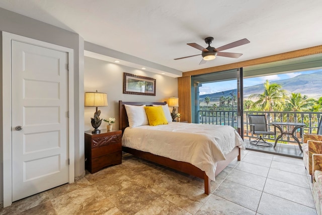 bedroom with access to exterior, ceiling fan, and a mountain view