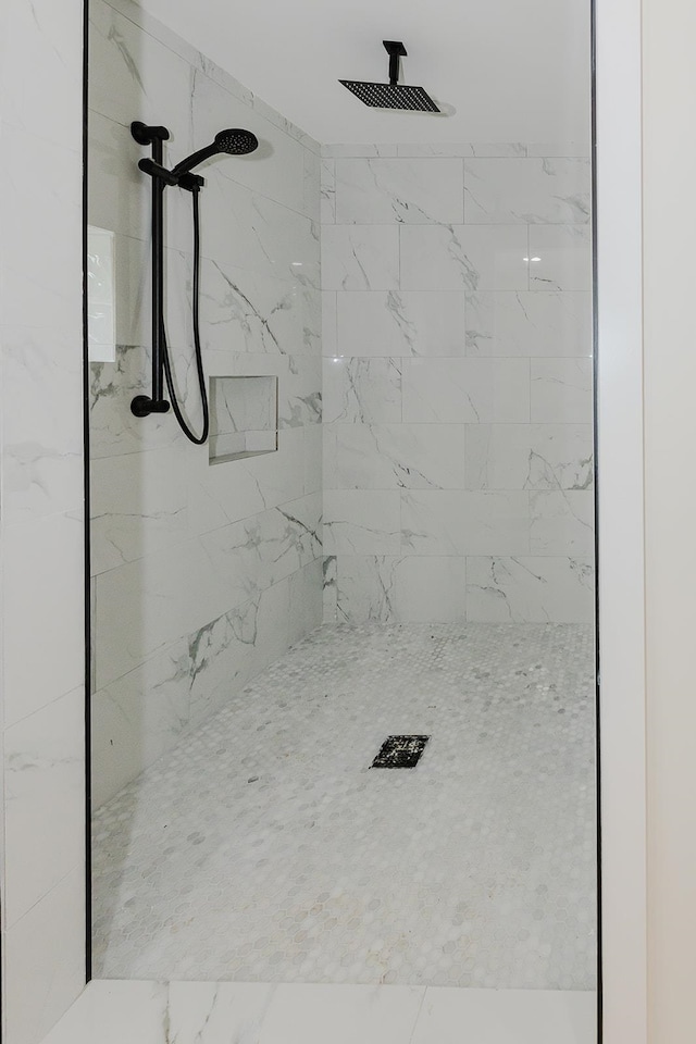 bathroom with a tile shower