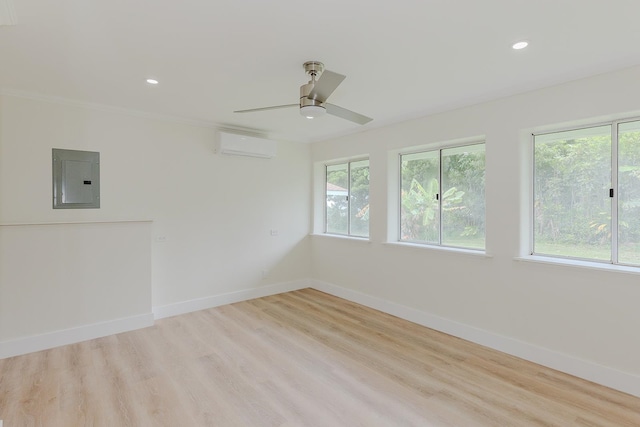 unfurnished room featuring a healthy amount of sunlight, a wall mounted AC, ceiling fan, and light hardwood / wood-style floors