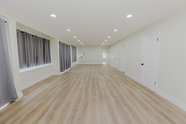 empty room with light hardwood / wood-style flooring