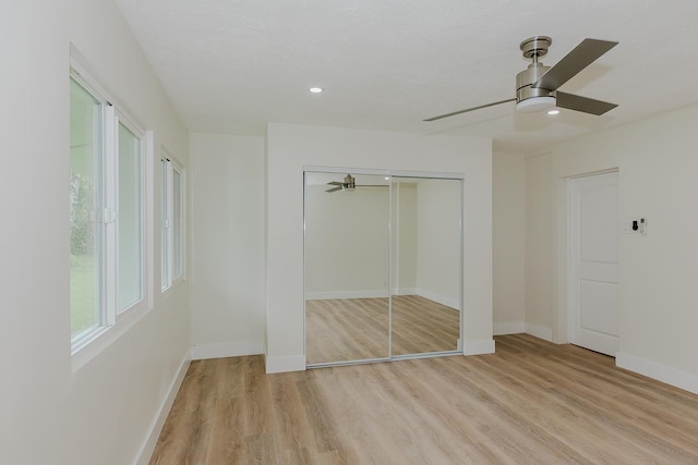 unfurnished bedroom with light hardwood / wood-style floors and ceiling fan