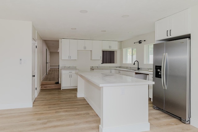 kitchen featuring stainless steel fridge with ice dispenser, white cabinetry, and light wood-type flooring