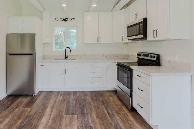 kitchen with light stone counters, sink, white cabinetry, stainless steel appliances, and dark hardwood / wood-style floors