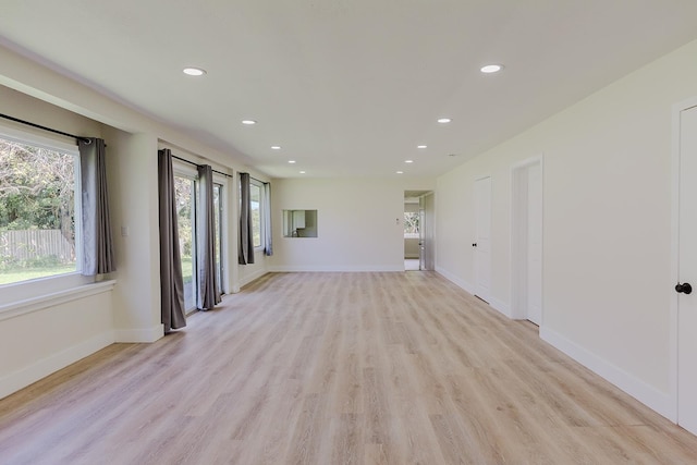 spare room with light hardwood / wood-style flooring