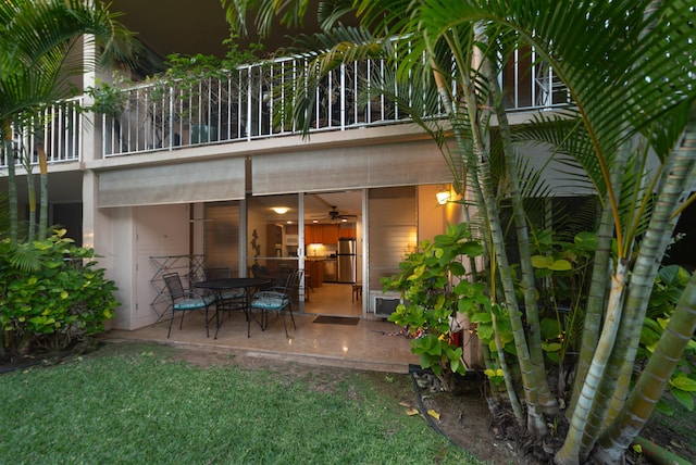 rear view of property with a patio area and a balcony