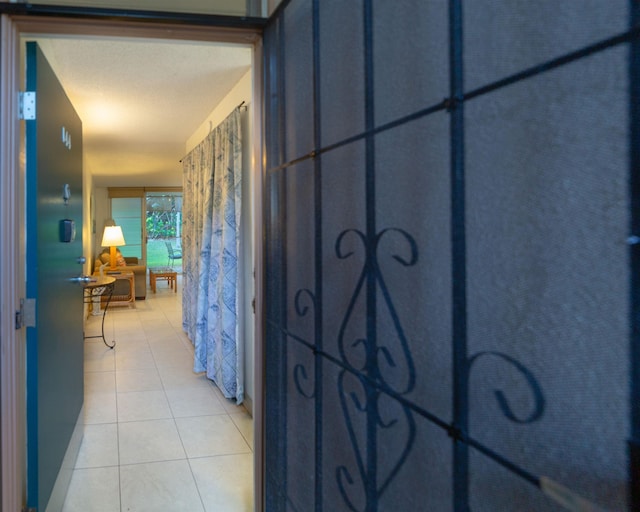 hallway featuring light tile patterned flooring