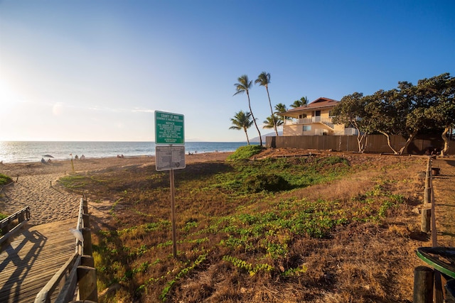 view of yard featuring a view of the beach and a water view