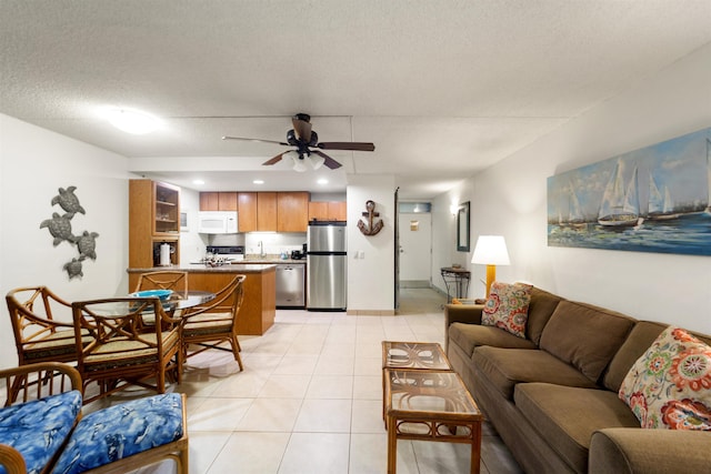 tiled living room with ceiling fan and a textured ceiling