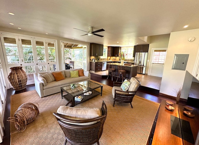 living room featuring light hardwood / wood-style flooring and ceiling fan