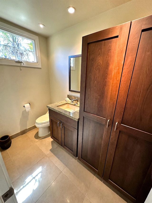 bathroom featuring vanity, tile floors, and toilet