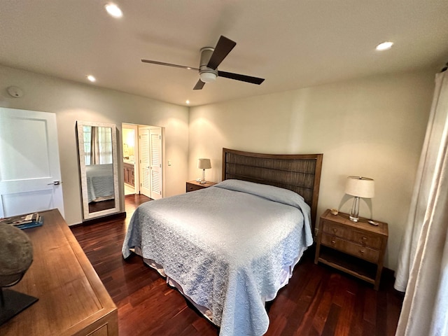 bedroom with dark hardwood / wood-style flooring, ceiling fan, and connected bathroom