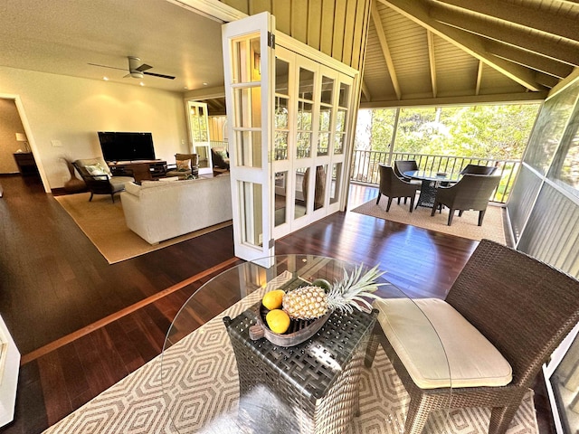 living room featuring ceiling fan, lofted ceiling with beams, and dark hardwood / wood-style floors