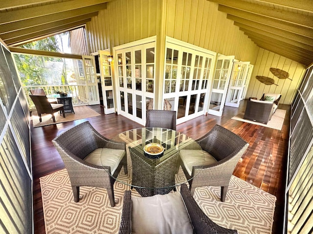 sunroom / solarium featuring french doors and lofted ceiling with beams