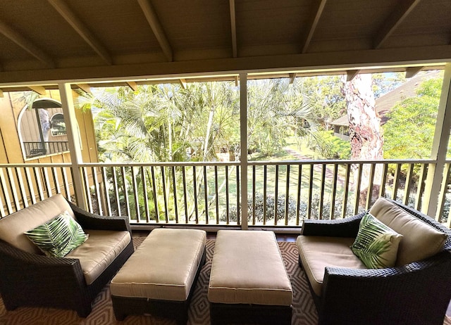 exterior space featuring vaulted ceiling with beams and a wealth of natural light