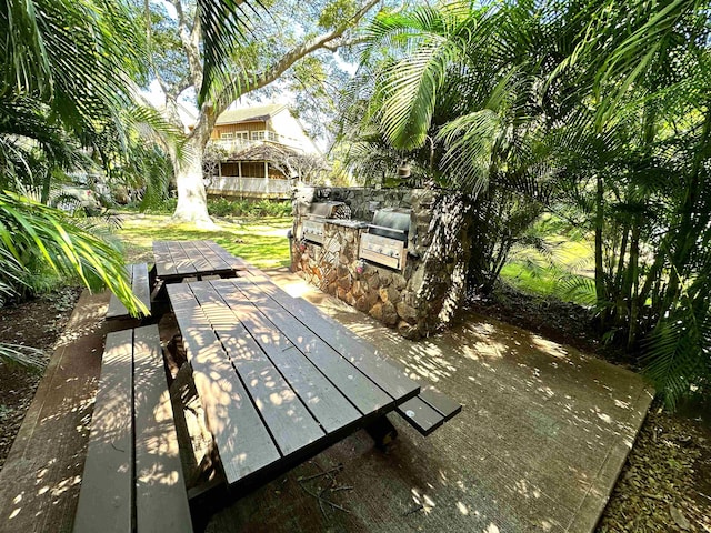 exterior space with exterior kitchen and a wooden deck