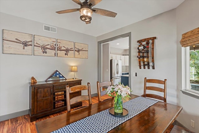 dining room with ceiling fan and dark wood-type flooring